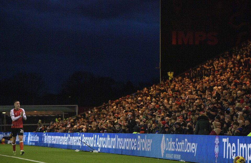 Jack Moylan applauds the fans as he leaves the pitch with Dallas Scott Davey advertising on display.