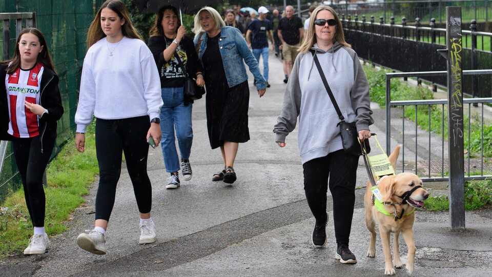A woman walking with her guide dog 