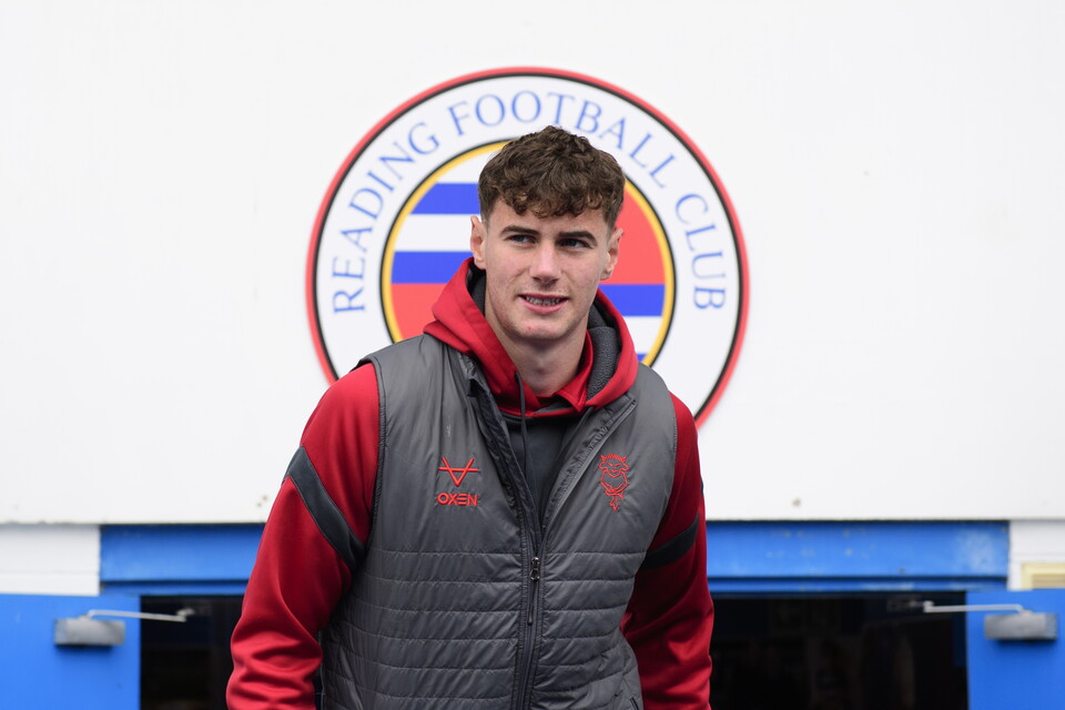 Joe Gardner in front of a Reading badge