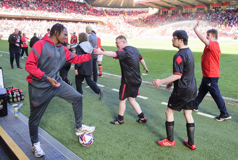 A man high fives another man