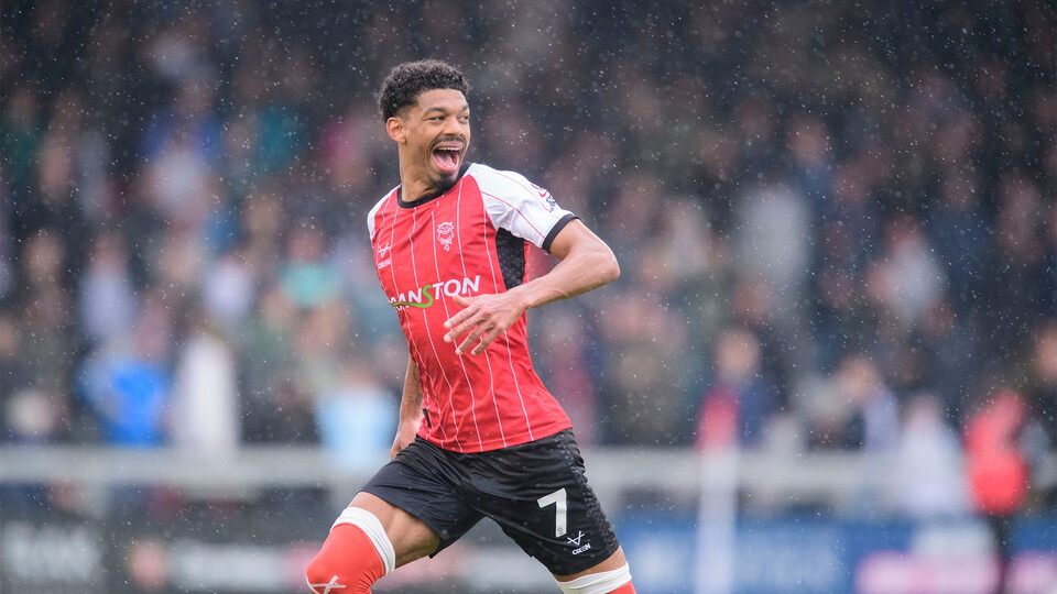 Reeco Hackett of Lincoln City celebrates scoring his side's fourth goal during the EFL Sky Bet League One match between Lincoln City and Bolton Wanderers at LNER Stadium, Lincoln.