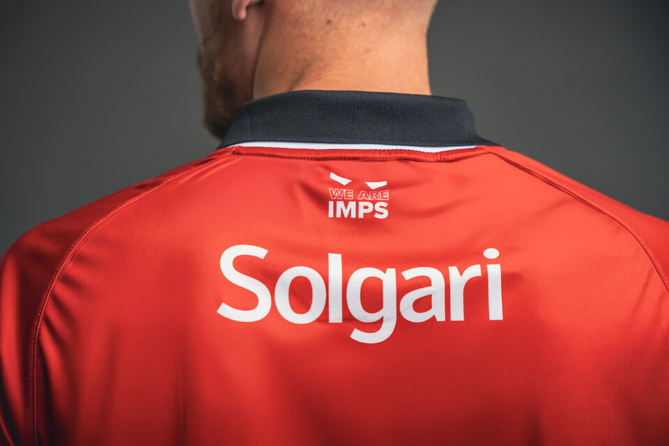 A close up of a red shirt with Solgari written in white text