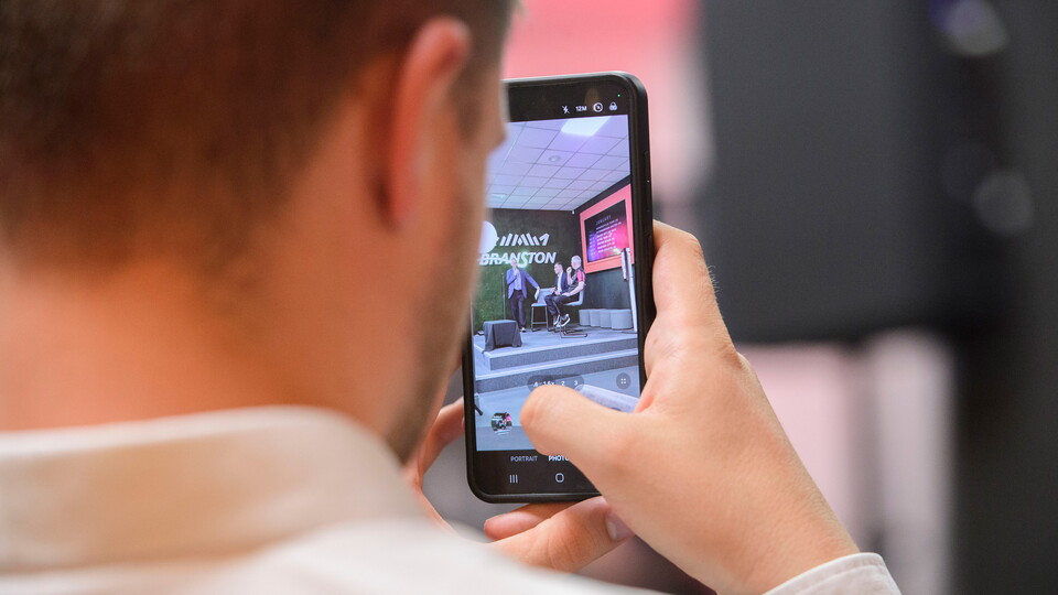 A man films via his mobile phone