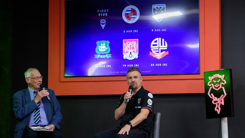 John Helm and Michael Skubala speak on stage