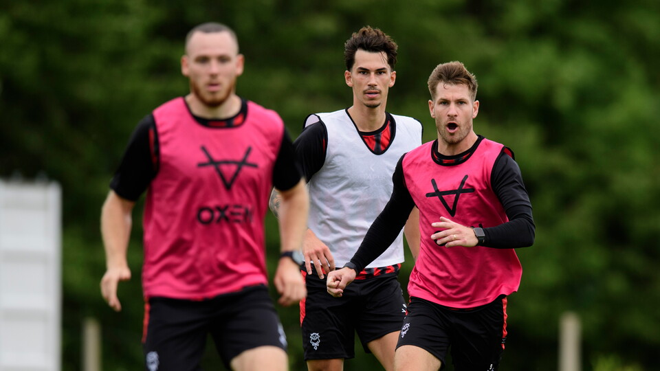 A group of men take part in a running drill.