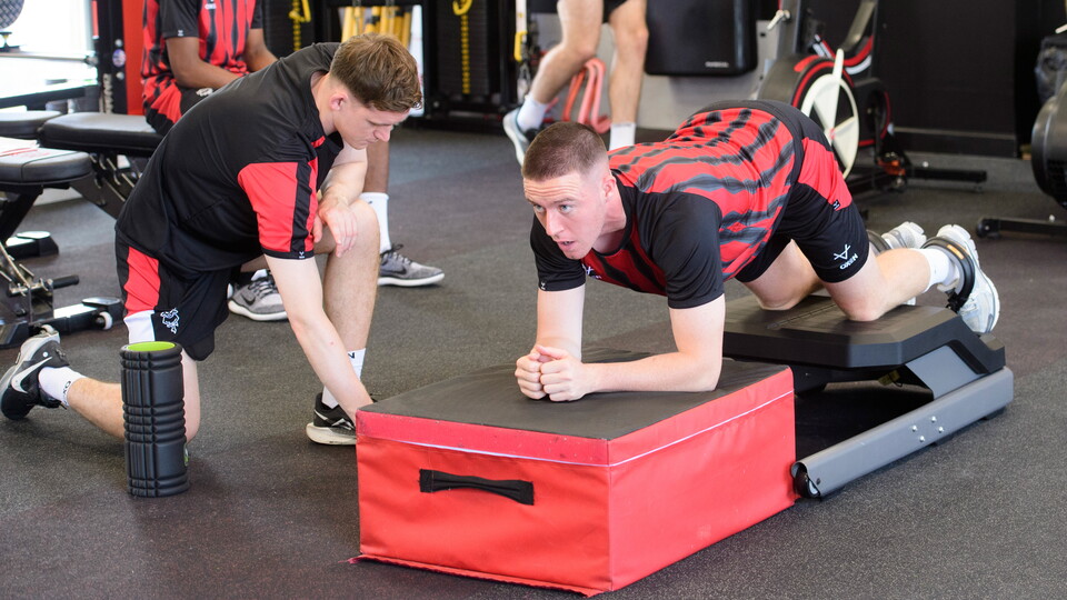 A man takes part in a testing exercise in a gym.