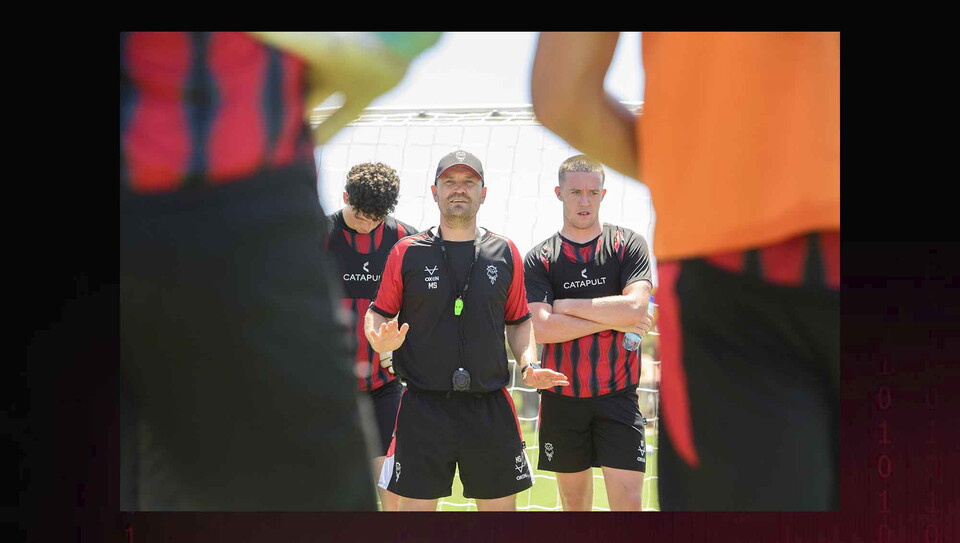 Head coach Michael Skubala talks to footballers during a training sessi