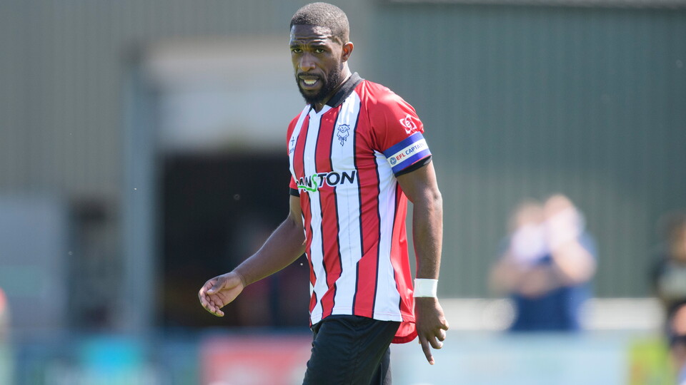 Tendayi Darikwa stands. He is wearing the captain's armband