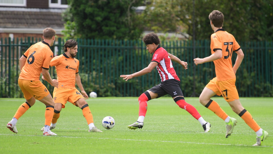 Jovon Makama runs with the ball. There are three Hull City players trying to close him down.