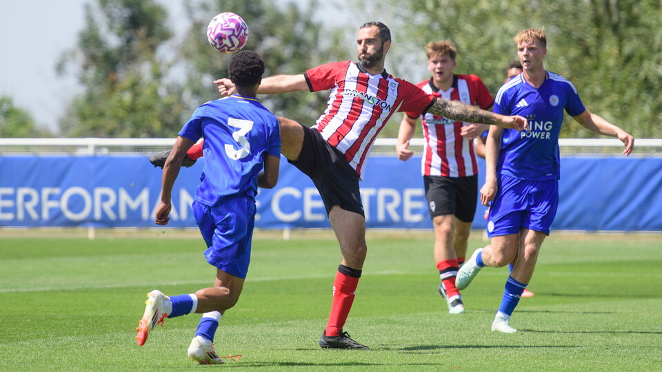 Adam Jackson arches as he shoots with his right foot.