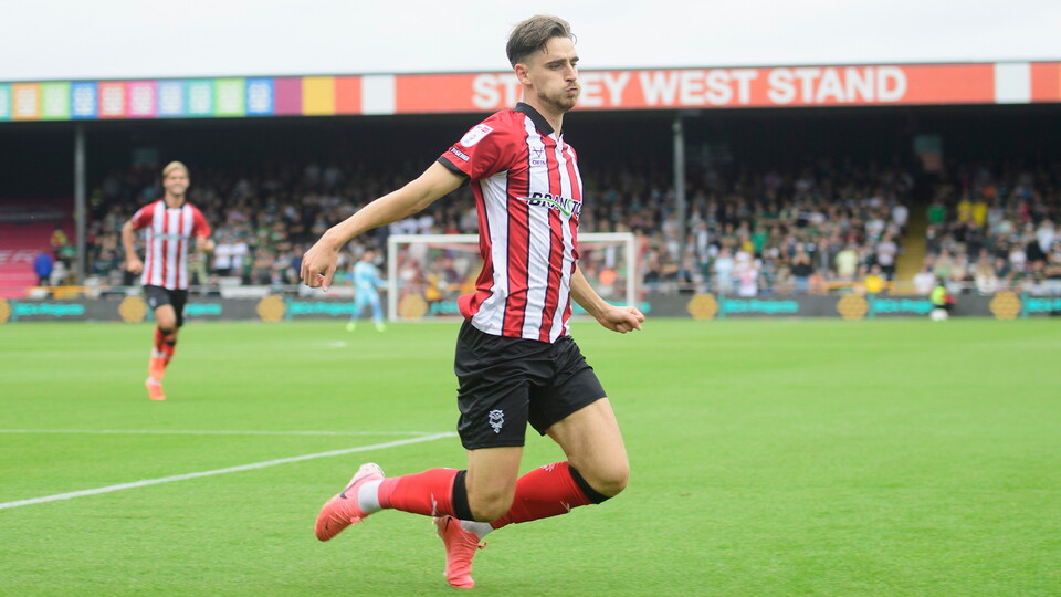 Tom Bayliss of Lincoln City celebrates scoring the opening goal during the EFL Sky Bet League One match between Lincoln City and Plymouth Argyle at LNER Stadium, Lincoln.