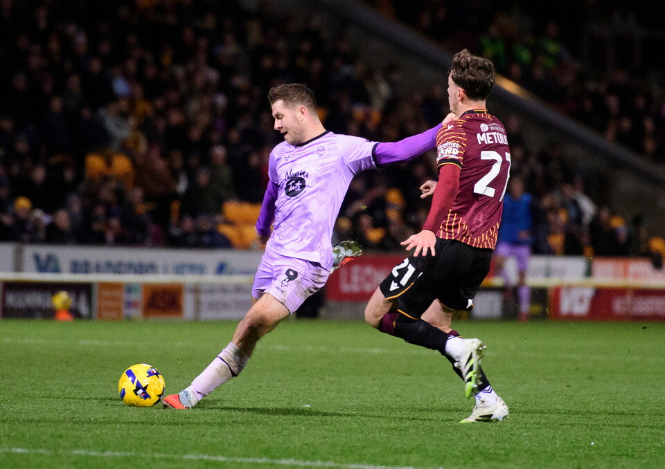 James Collins of Lincoln City under pressure from Jenson Metcalfe of Bradford City during the EFL Sky Bet League One match between Bradford City and Lincoln City at University of Bradford Stadium, Bradford.