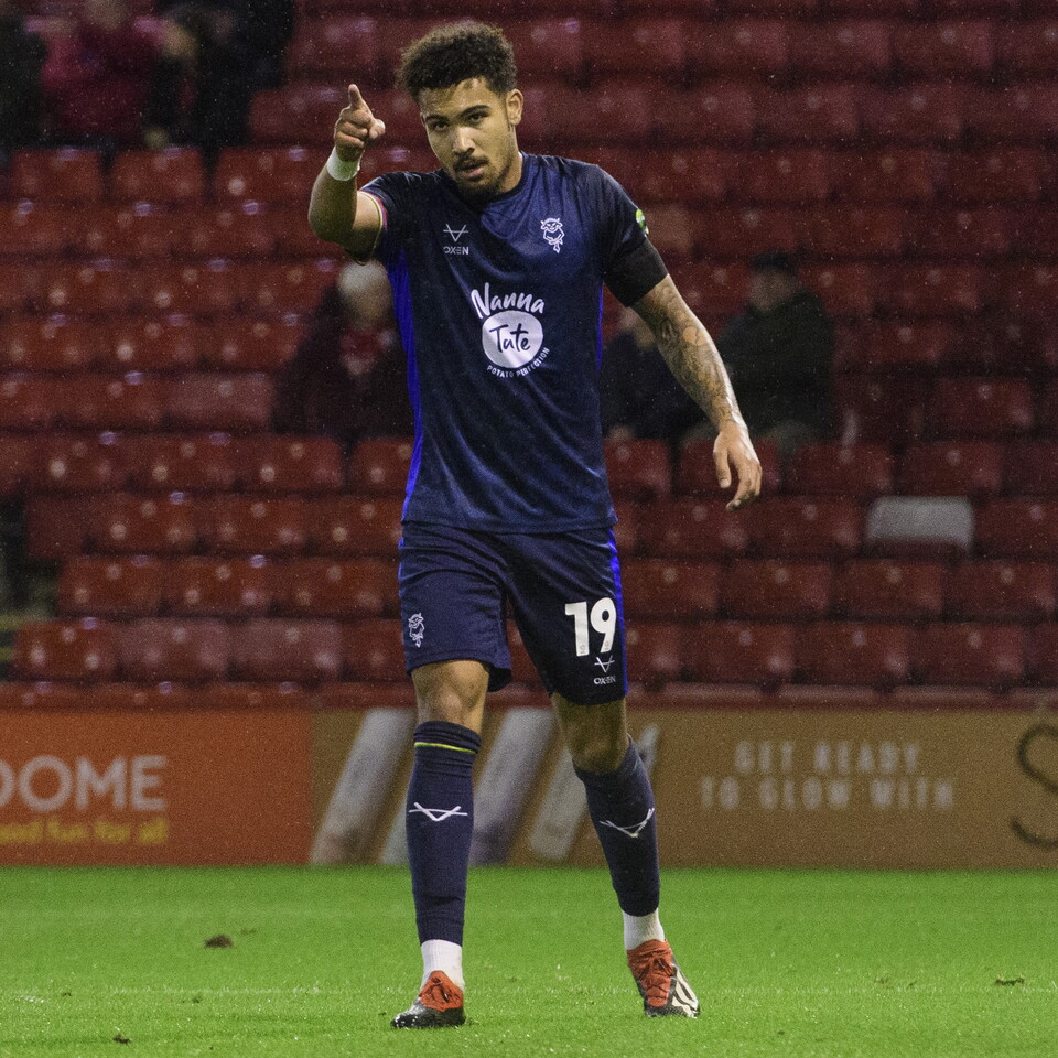 Frankie Okoronkwo points with his right hand in celebration after scoring a goal