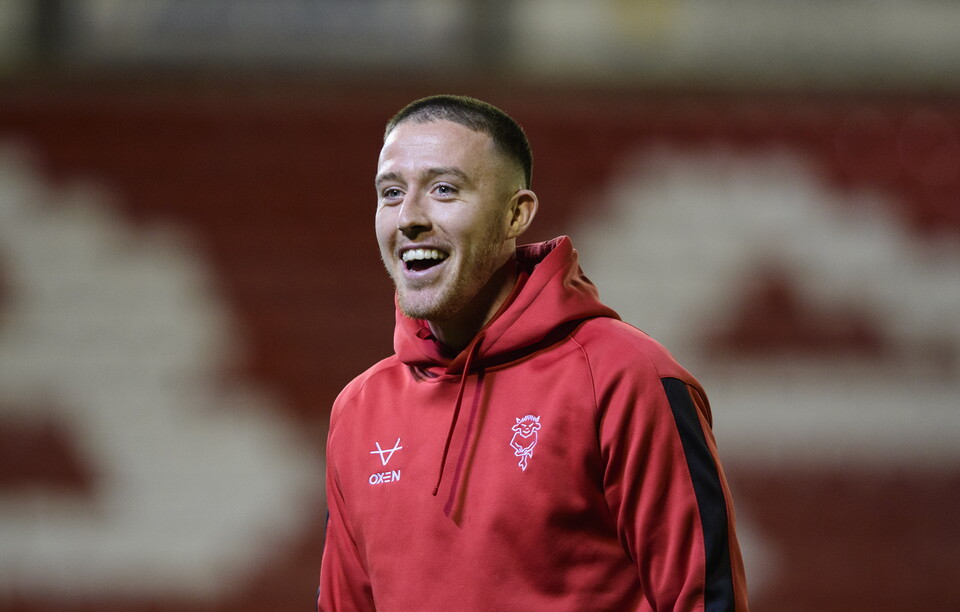 Jack Moylan laughs while wearing an all red hoody