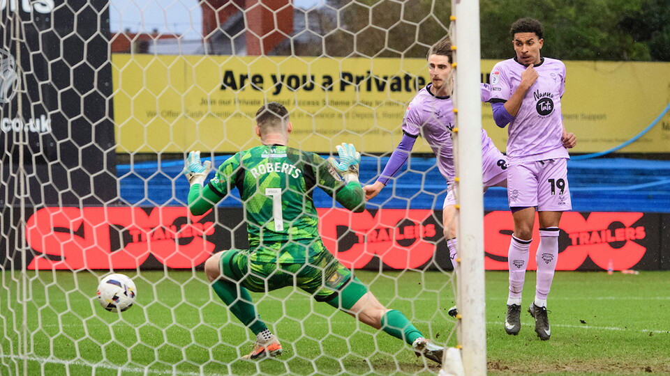 Tom Bayliss caps the victory with his goal for City at Mansfield