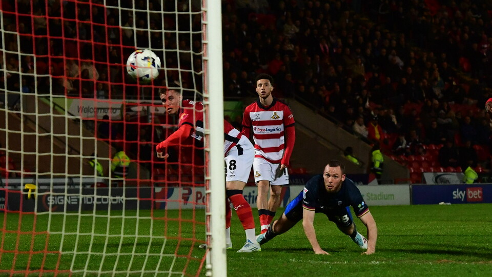 Ben House watches on after the ball goes into the net following his header.