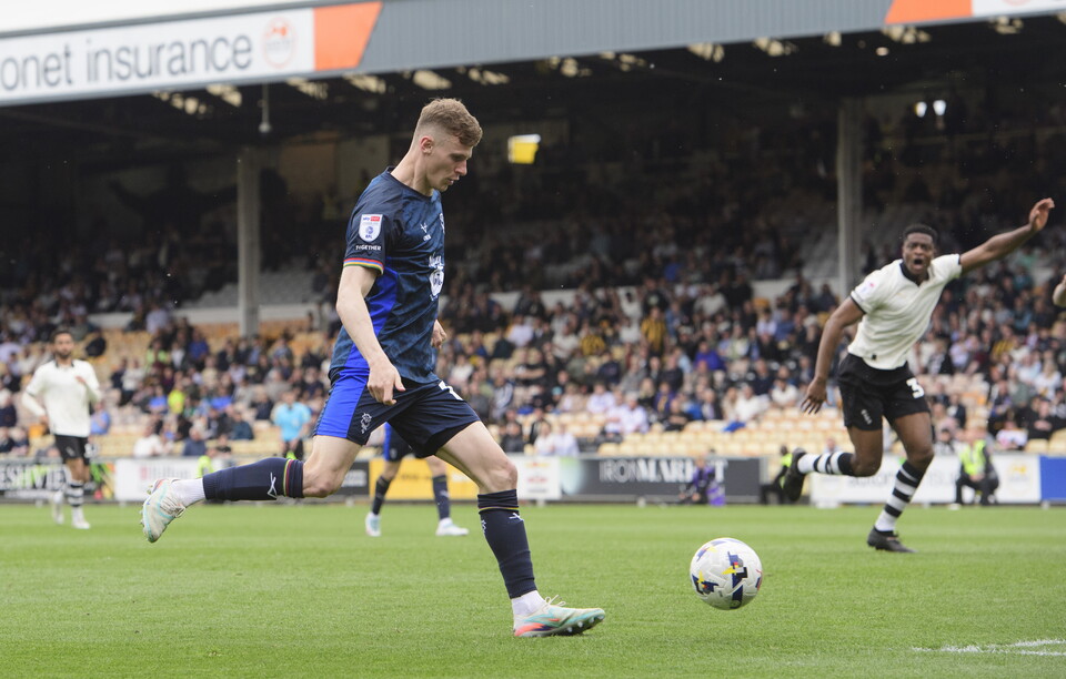 Rob Street kicks the ball with his right foot to score.