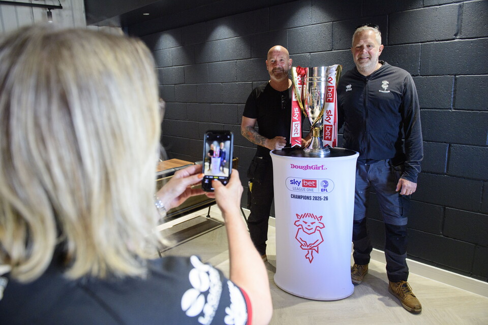 Fans pose for a photo at the opening of the clubhouse