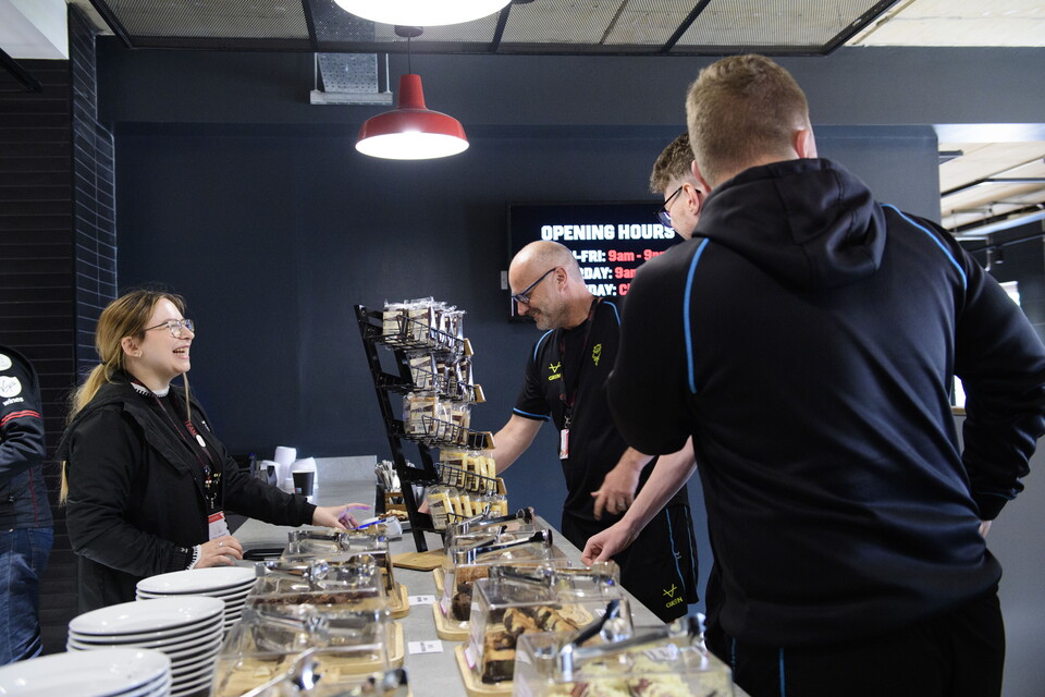 A general shot of people being served at a counter