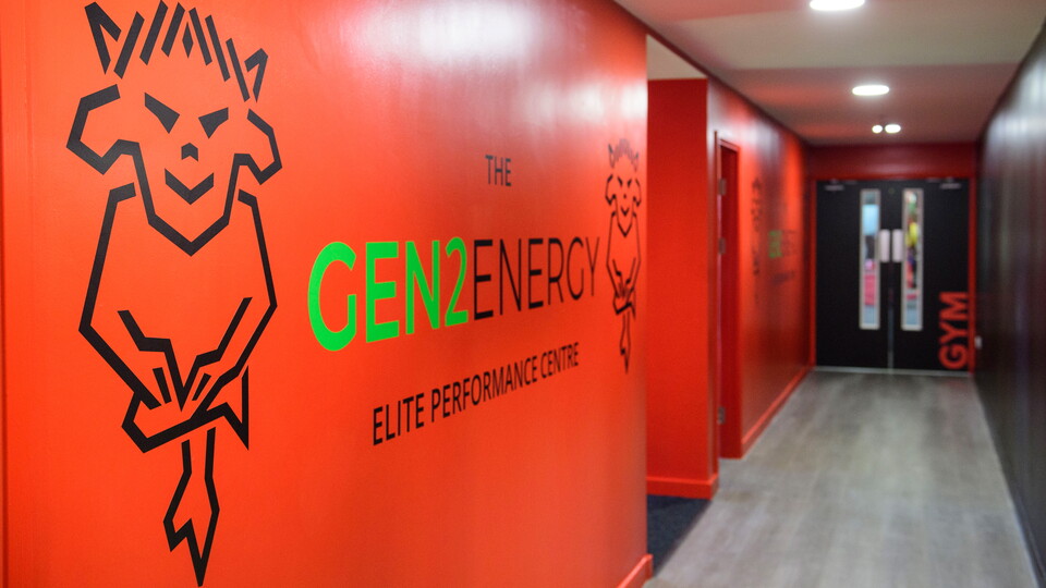 A corridor with a "Gen2 Energy" sign on the wall