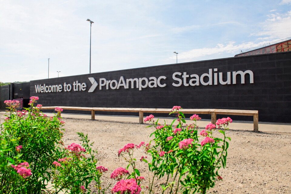 Flowers in front of a sign which reads Welcome to the ProAmpac Stadium