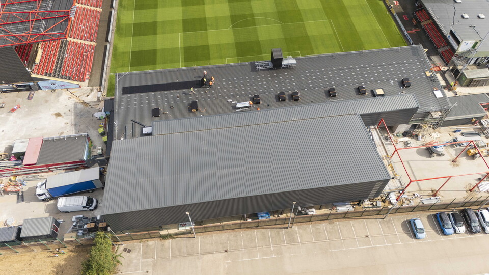 Solar panels being installed on the roof of a building