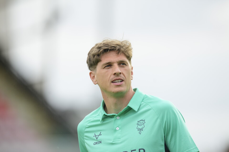Adam Reach in teal training kit