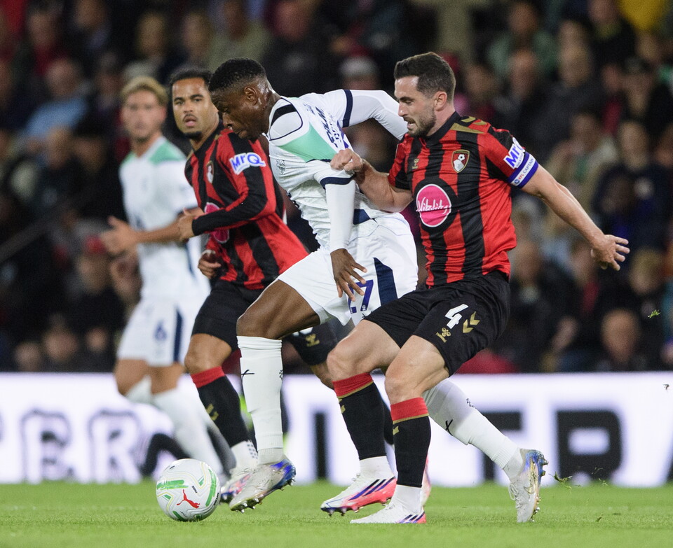 Chieo Ogbenne runs past two Bournemouth players