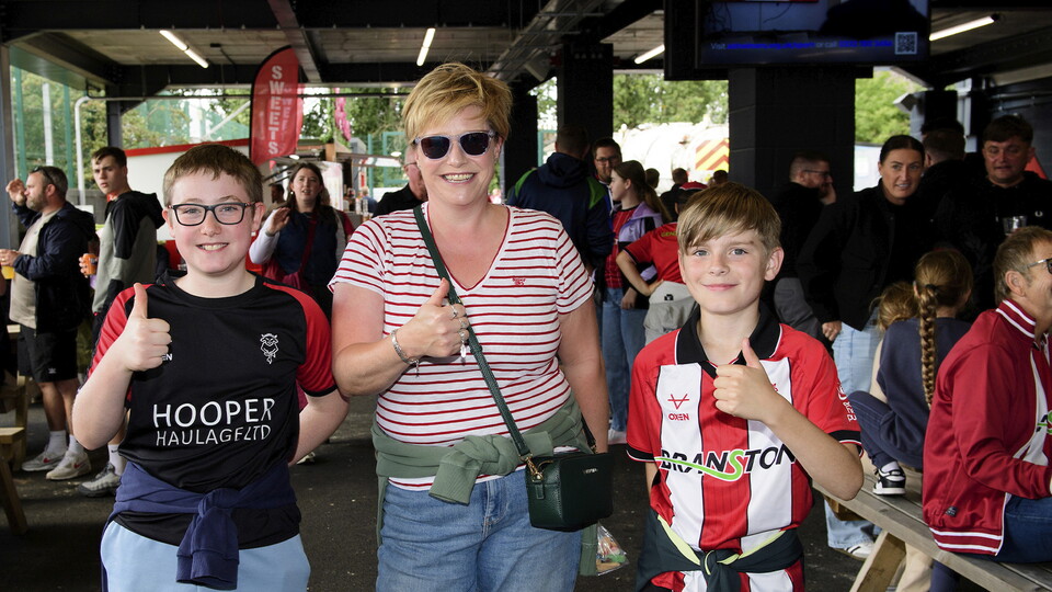 Three fans photographed inside the Fan Village
