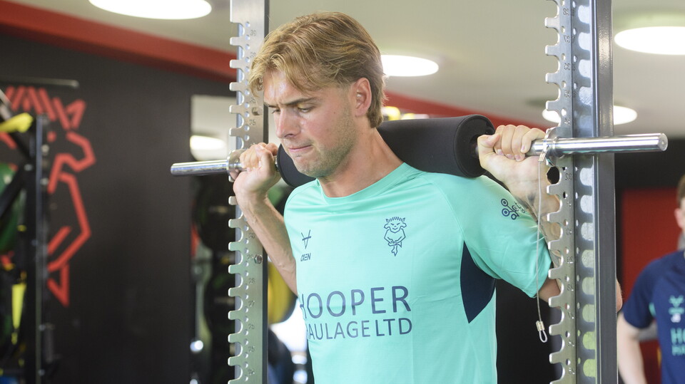 Ryley Towler pushes against a piece of gym equipment