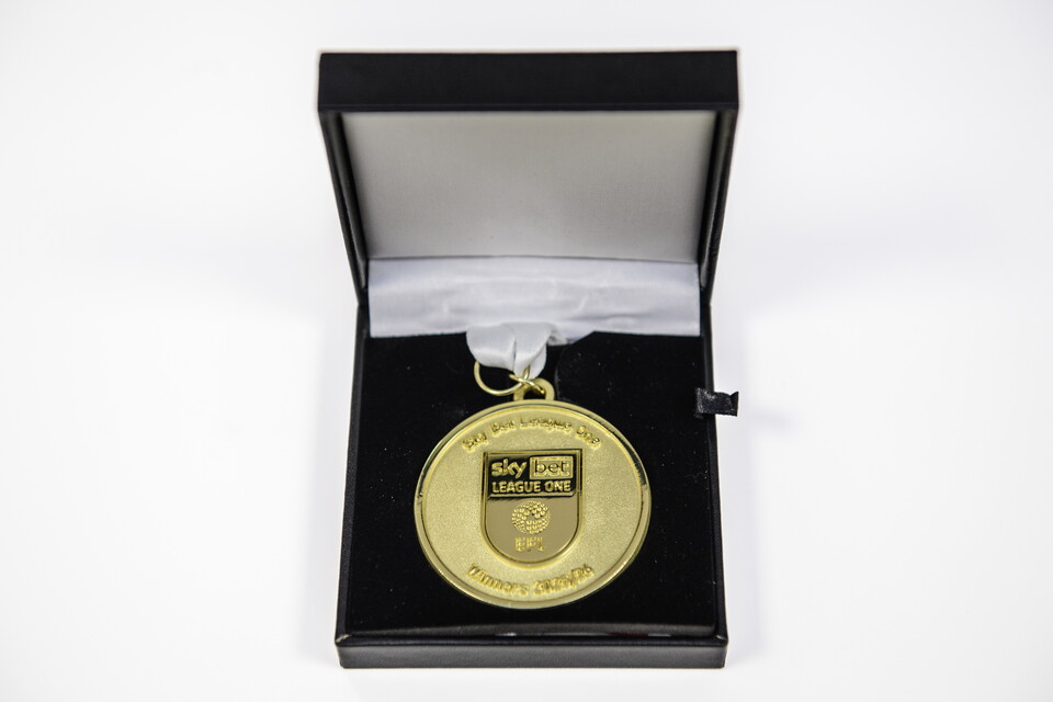 A close up of a League One winners medal in a presentation box