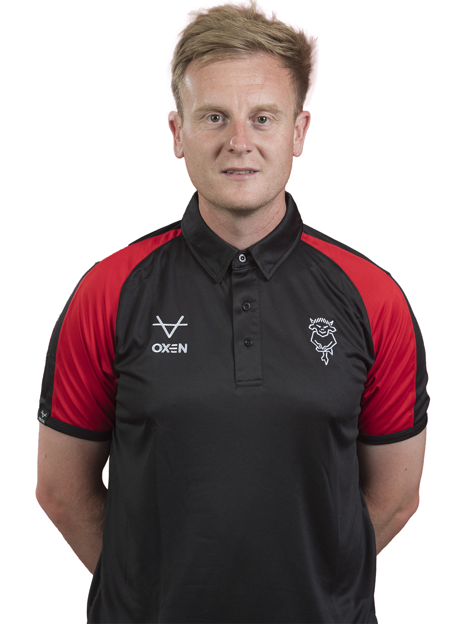 Joe Hutchinson poses in a black polo shirt