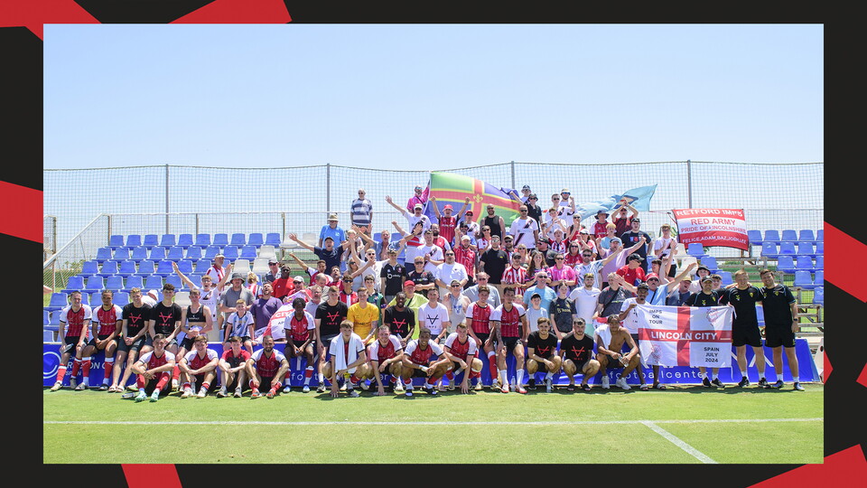 Lincoln City's players and fans pose for a picture after the friendly against Preston North End.