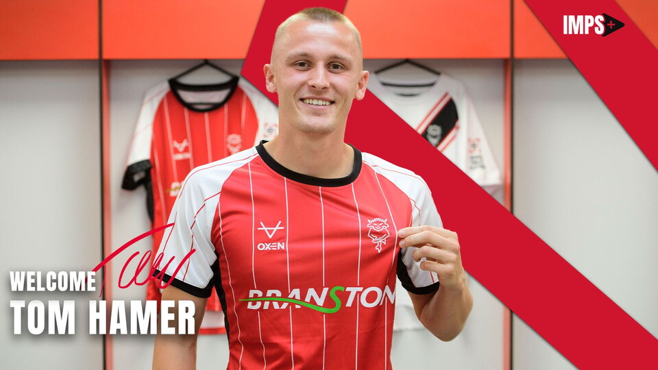 A graphic showing Tom Hamer at the LNER Stadium. He is wearing a red and white home shirt