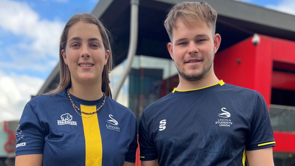Football presidents from the University of Lincoln pose with a football.