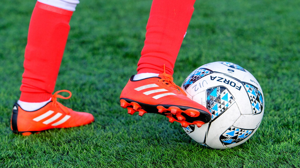 A player dribbles a football