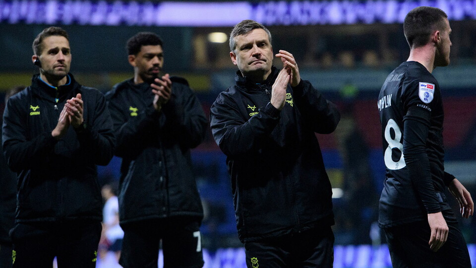 Head coach Michael Skubala applauds the fans after City's away game at Bolton Wanderers