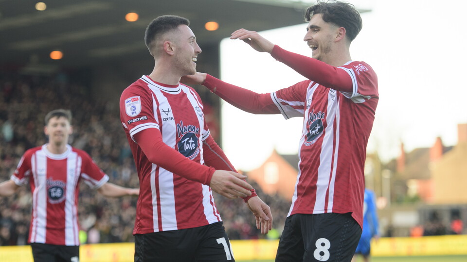 Two Lincoln City players celebrating 