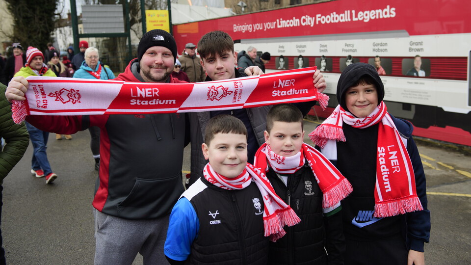 Supporters hold up scarves