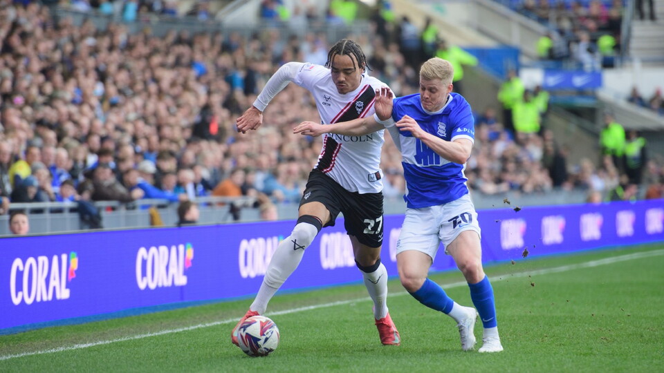 Jovon Makama running down the right flank with Alex Cochrane of Birmingham City challenging him for the ball.
