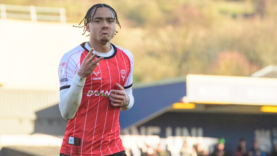 Jovon Makama holds up three fingers as he celebrates scoring a hat-trick.