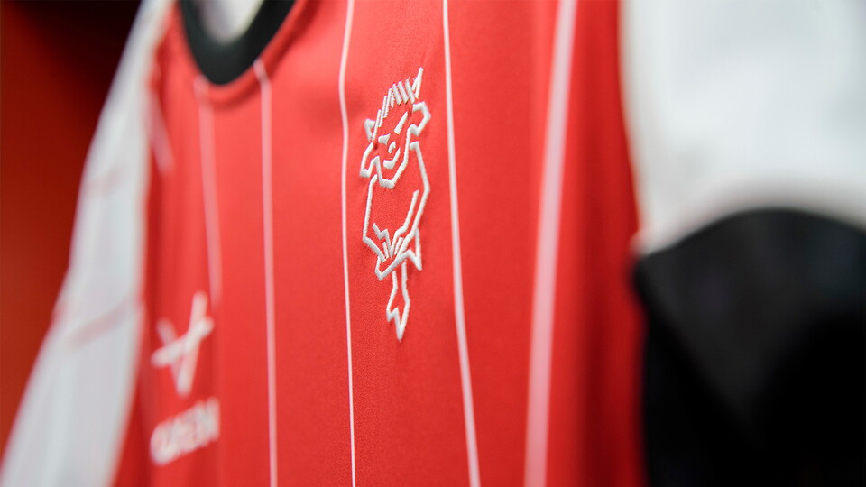 A picture of a Lincoln City home shirt hung up in the dressing room.