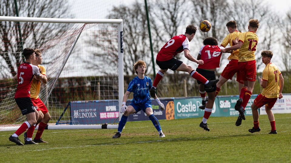 Will Cowin heads a ball towards goal