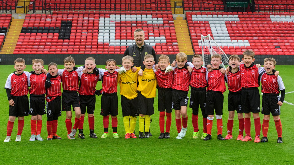 Michael Skubala, head coach of Lincoln City with Lincoln City Academy players following the EFL Sky Bet League One match between Lincoln City and Bolton Wanderers at LNER Stadium, Lincoln.