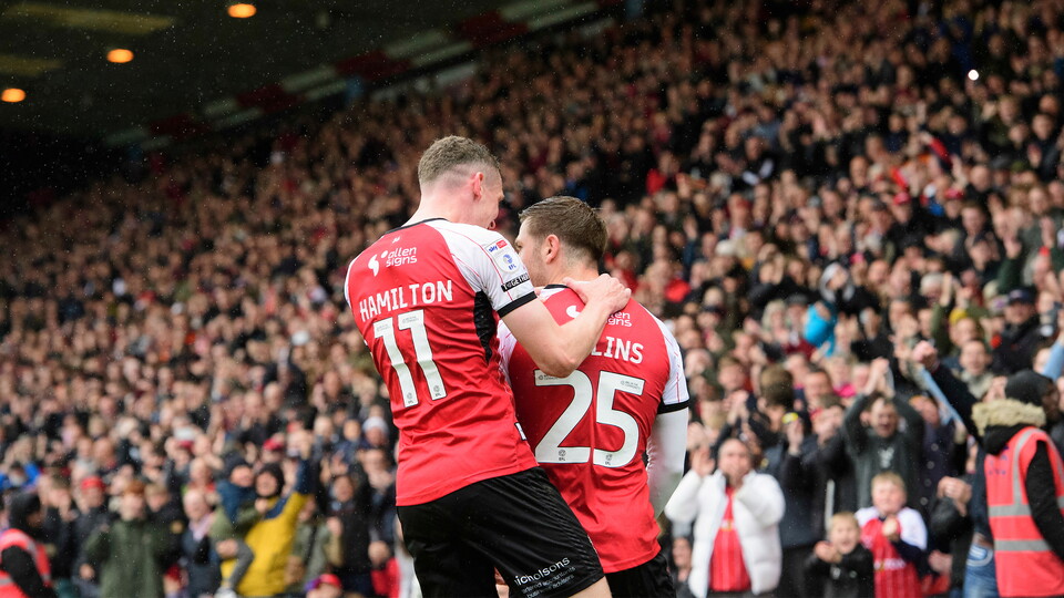 James Collins of Lincoln City, right, celebrates scoring his side's second goal from the penalty spot with team-mate Ethan Hamilton during the EFL Sky Bet League One match between Lincoln City and Bolton Wanderers at LNER Stadium, Lincoln.