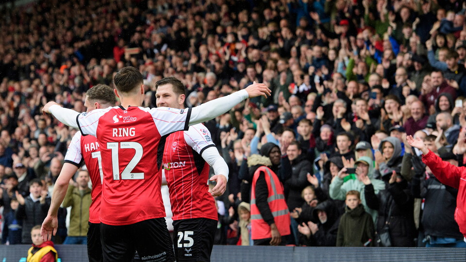 James Collins of Lincoln City, right, celebrates scoring his side's second goal from the penalty spot with team-mate Erik Ring during the EFL Sky Bet League One match between Lincoln City and Bolton Wanderers at LNER Stadium, Lincoln.