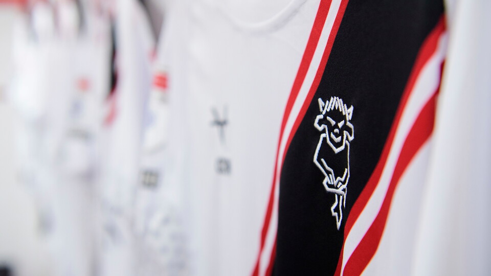 A close-up picture of a Lincoln City away shirt hung up in the away dressing room.
