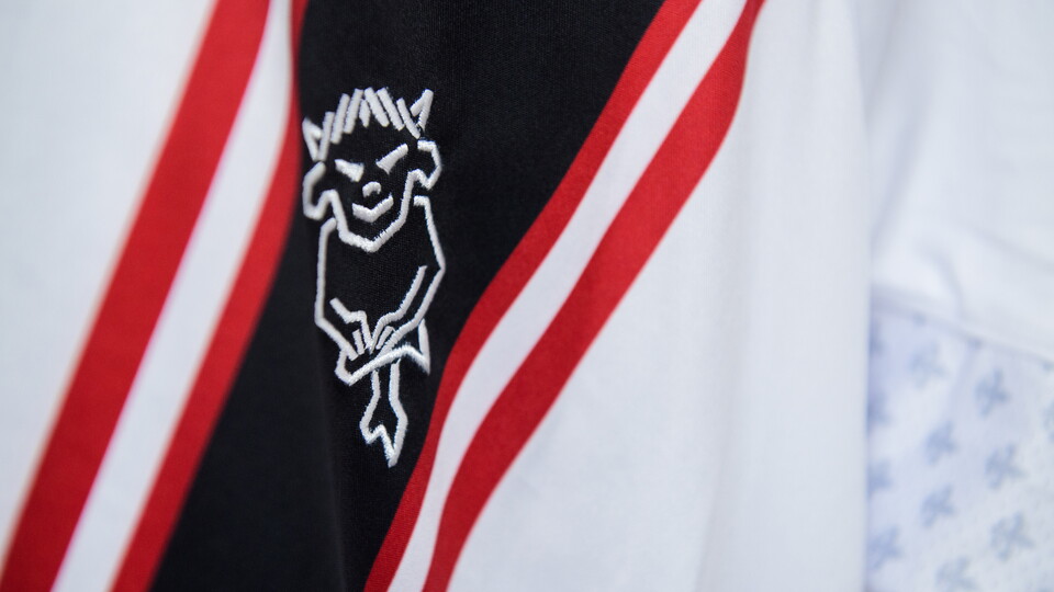A close up of the Lincoln City badge on a white shirt