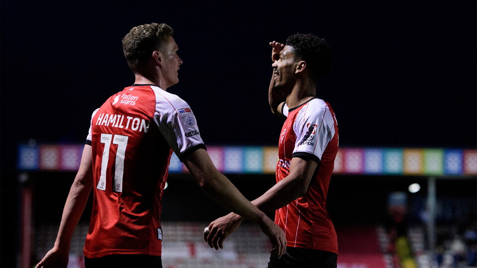 Reeco Hackett celebrates giving Lincoln City the lead against Huddersfield Town.