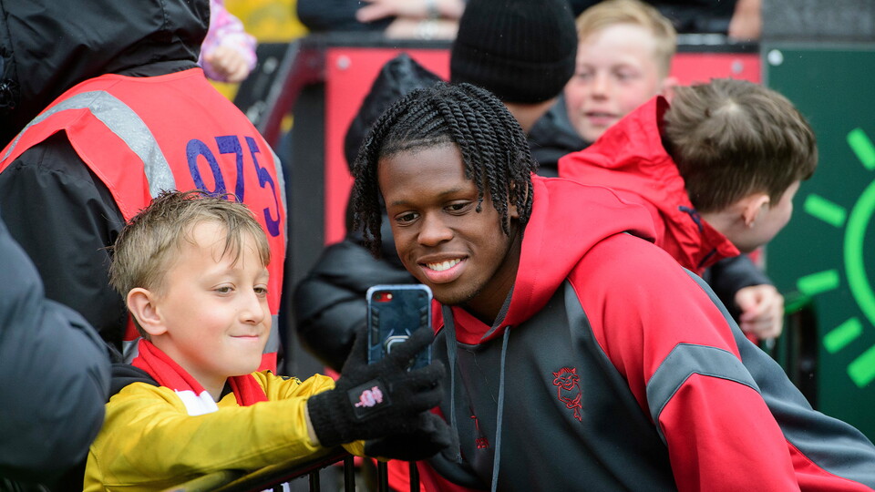 Zane Okoro of Lincoln City poses for a selfie with a fan prior to the EFL Sky Bet League One match between Lincoln City and Bolton Wanderers at LNER Stadium, Lincoln.